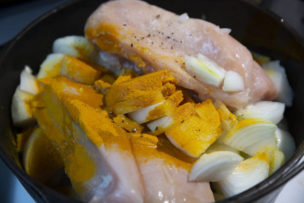 Raw chicken with onions and spices