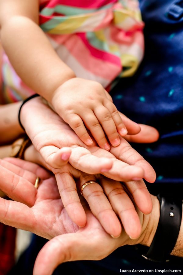 Touching hands - a family from baby to grandmother. Image: Luana Azevedo on Unsplash.com