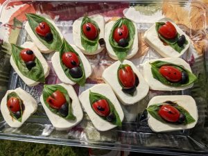 Display of savory olive treats that look like ladybugs. Image: Rachel Cogbill.