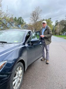 Man standing next to a car. Image: Kelly McCracken
