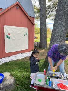 Little girl gets ready to make a handprint painting. Image: K. McCracken