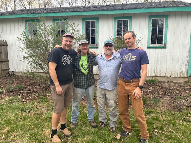 Four men smiling at the camera. Image: Small Axe 2026